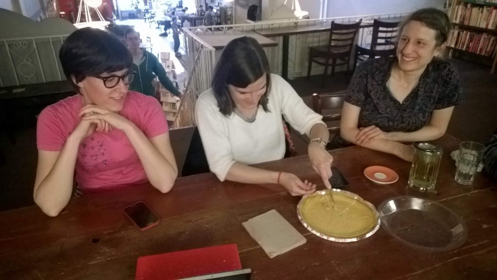 Katherine, Eli cutting a pumpkin cheesecake, Julie